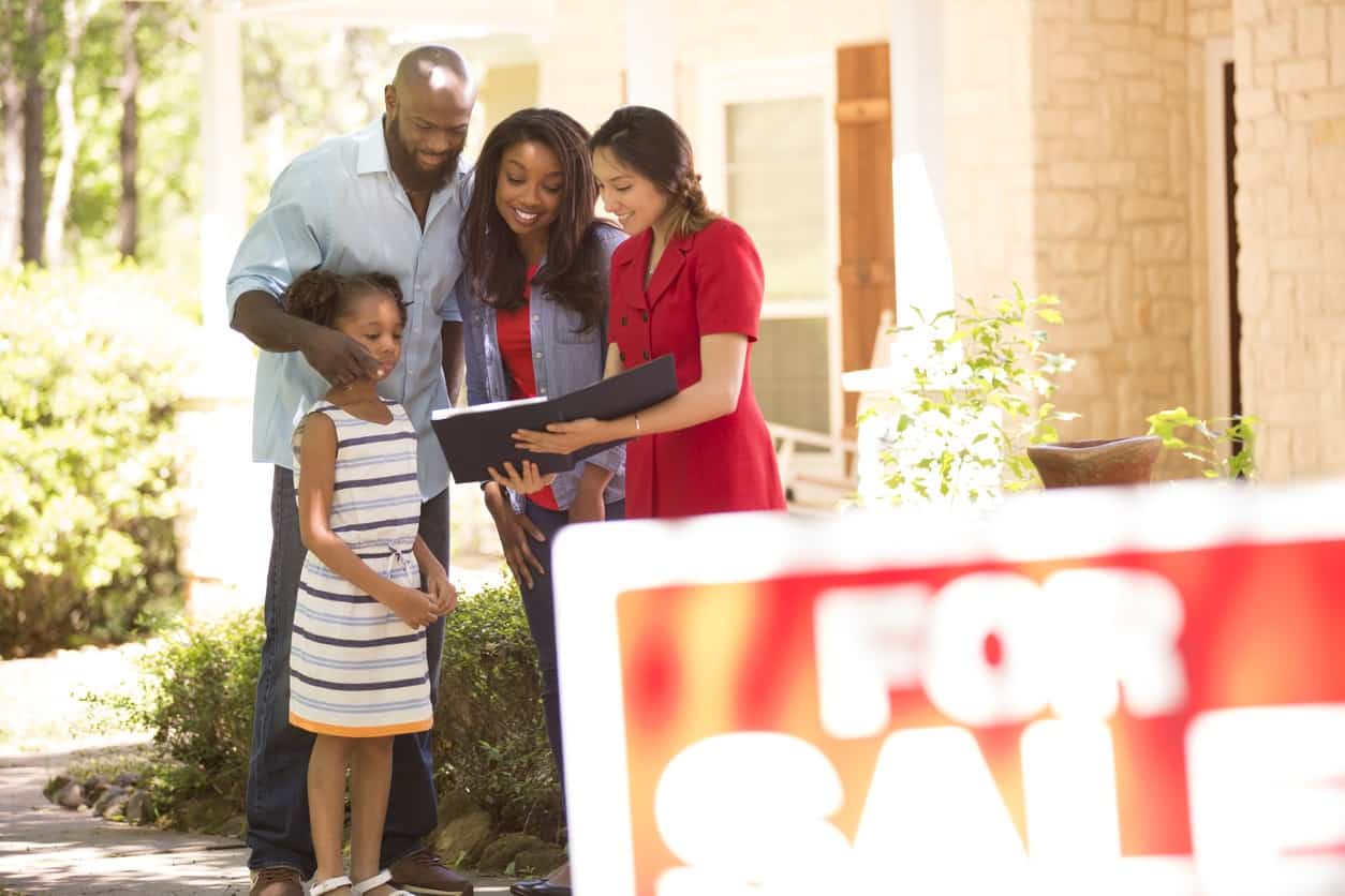 Realtor and family looking at new home to purchase.